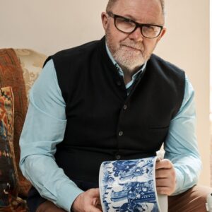 Anthony Lovett holding a blue and white Chinese ceramic