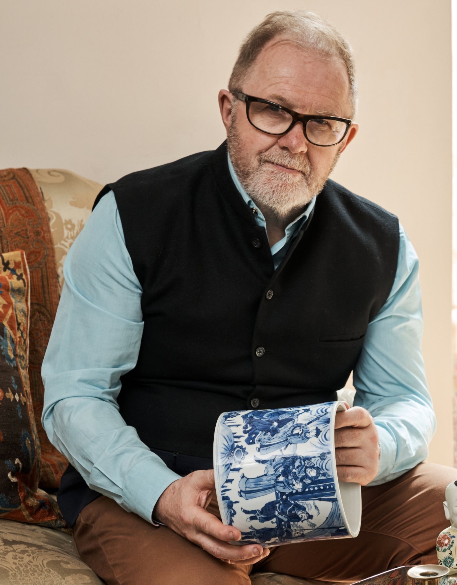 Anthony Lovett holding a blue and white Chinese ceramic