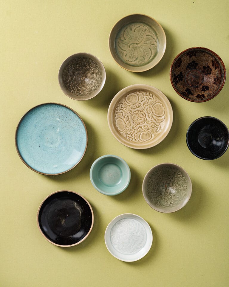 Santos Collection of Early Ceramics - 10 ceramics against a yellow plain background. courtesy of chiswick auctions