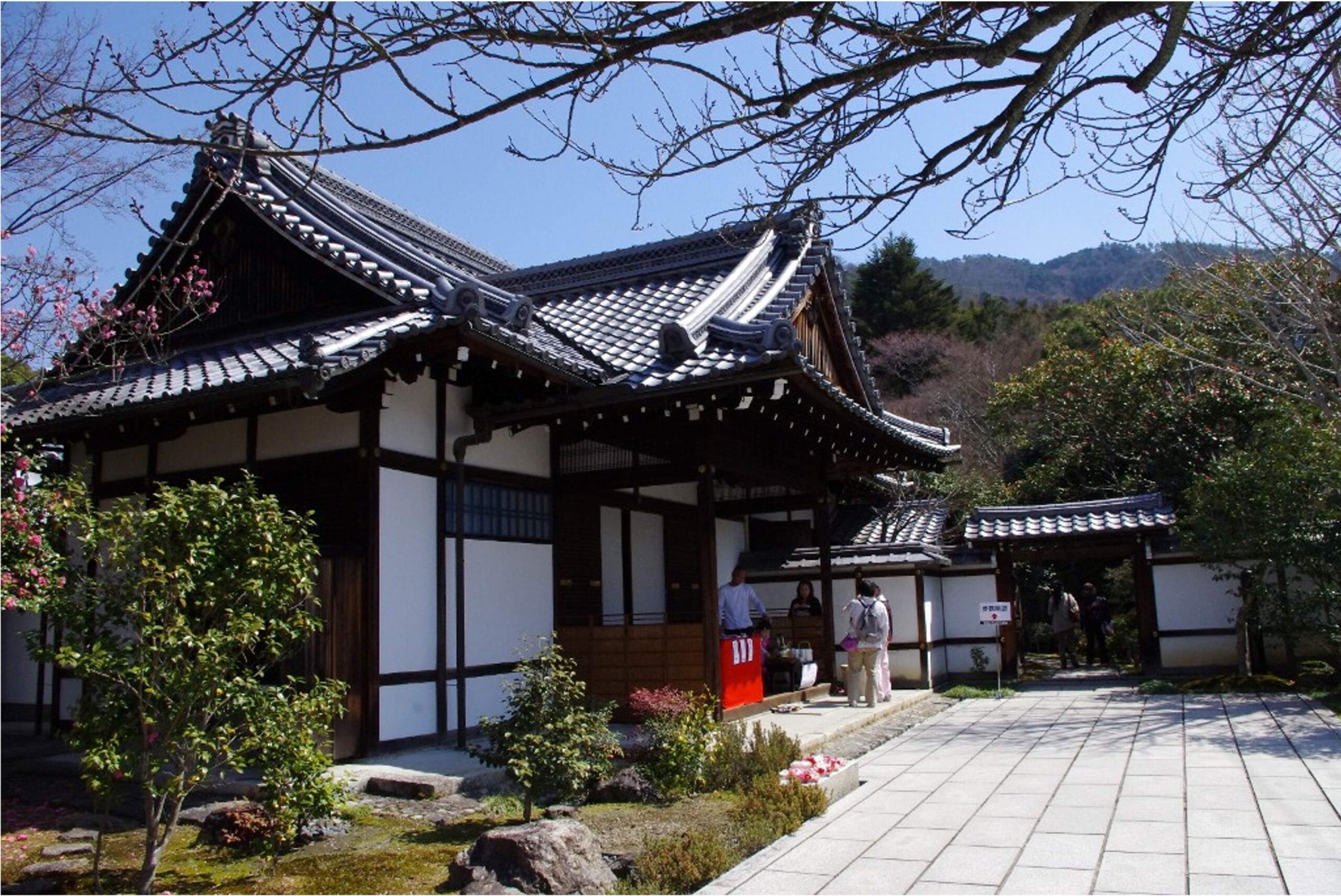A pagoda among trees below a hill