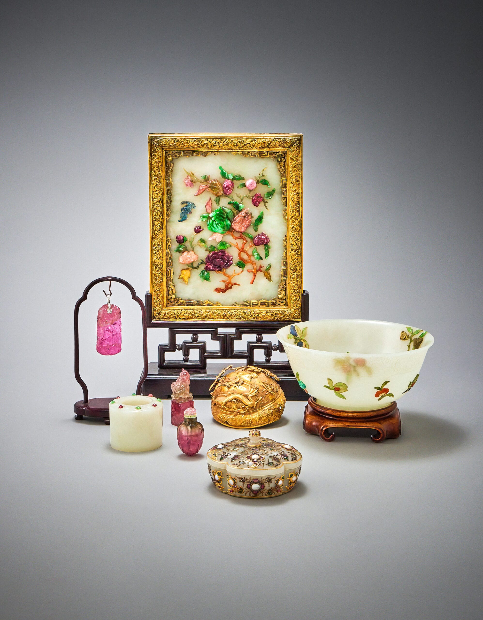 a selection of jade objects including a picture , bowl and pendant